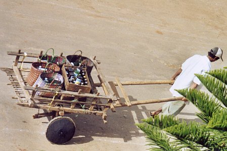 Man pulling wooden cart