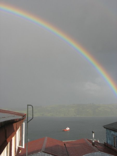 theferryconnectingcastrotothemainlandabouttodockunderacolourfulrainbow.jpg